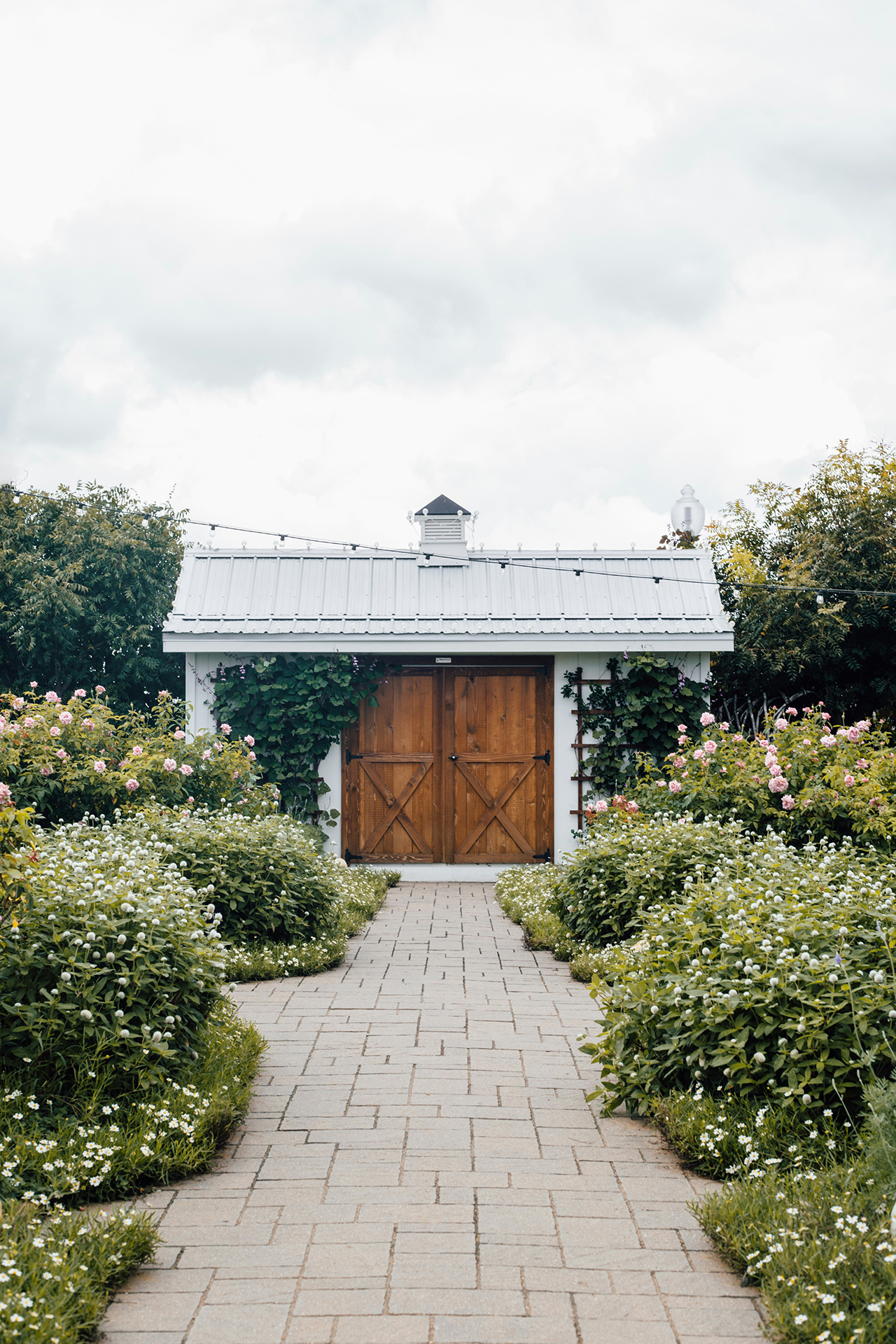 Renovated farmhouse exterior by DHHS Team with classic architecture and picturesque setting